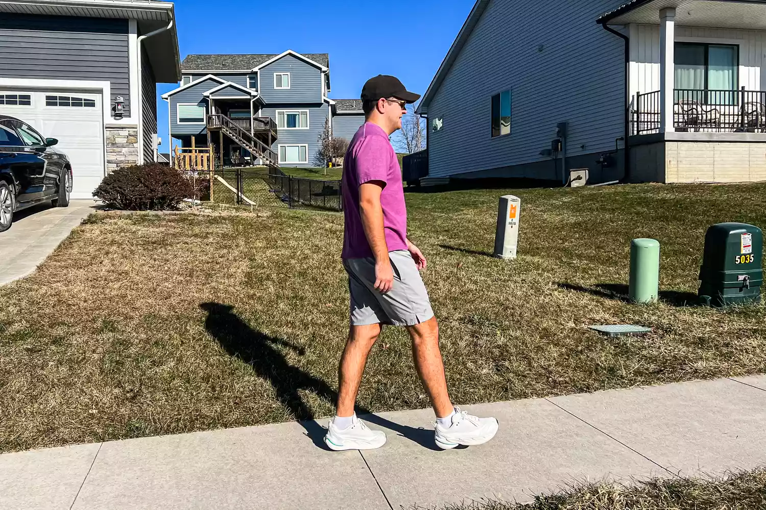 A person walks outside while wearing the Hoka All Gender Elevon X Running Shoes