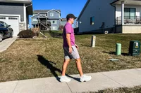 A person walks outside while wearing the Hoka All Gender Elevon X Running Shoes