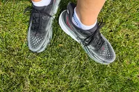 An overhead view of a person wearing the Hoka Men's Clifton 9 Running Shoe in grass