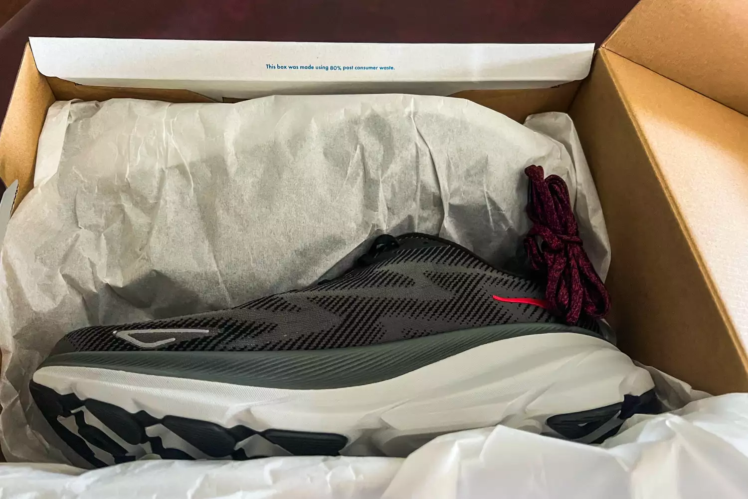 The Hoka Men's Clifton 9 Running Shoes in a shoe box