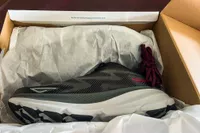The Hoka Men's Clifton 9 Running Shoes in a shoe box