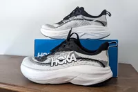 The Hoka Women's Skyflow sneakers posed around a box