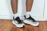 A close-up of two feet in the Hoka Women's Skyflow