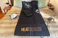 The Heat Healer Infrared Sauna Blanket on a bed