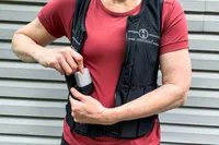 A person removes a weight from the Hyperwear Women's Hyper Vest Fit Weighted Vest