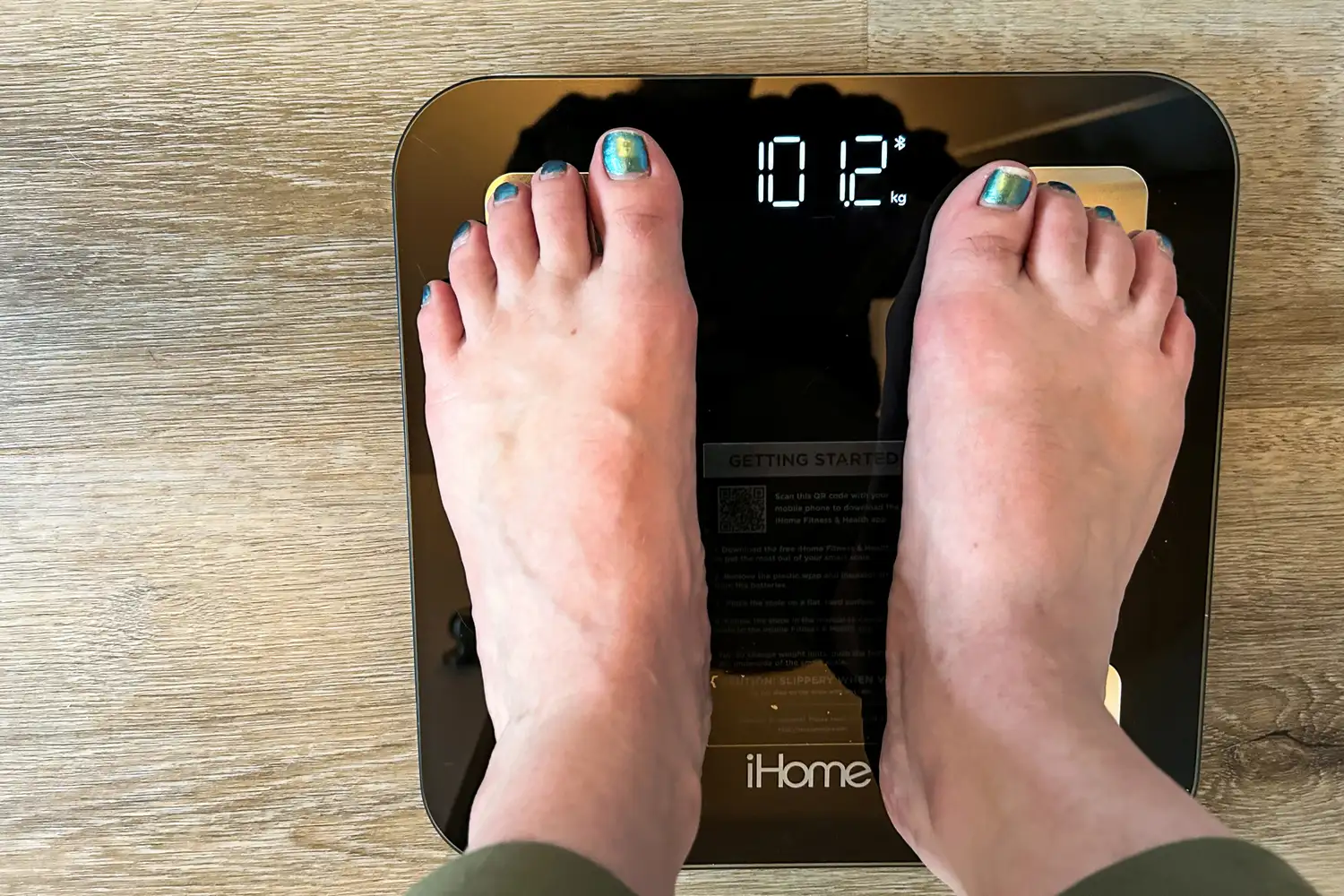 A person stands on the iHome Smart Bluetooth Digital Scale