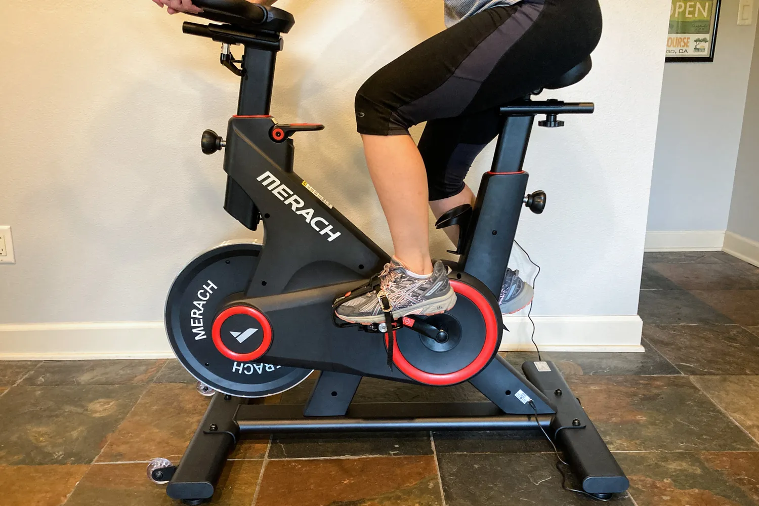 A person cycles on the Merach S09 Auto Resistance Bike