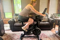 A person exercises using the Merach S26 Exercise Bike