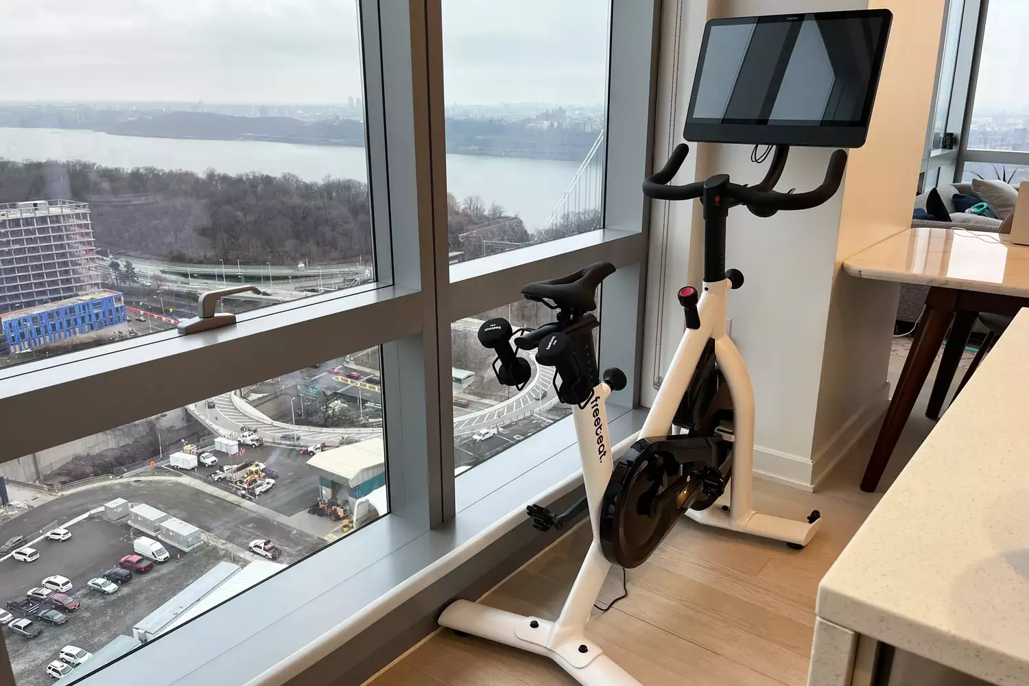 Freebeat Fit Lit Bike set up next to a tall window in an apartment