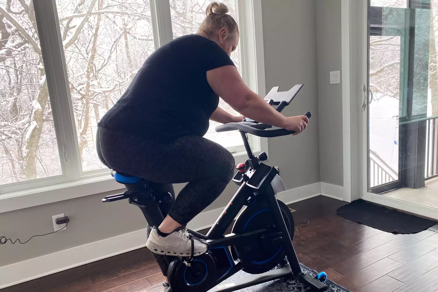 Person riding the Horizon 7.0 IC Indoor Cycle next to a window