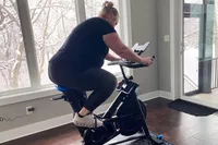 Person riding the Horizon 7.0 IC Indoor Cycle next to a window