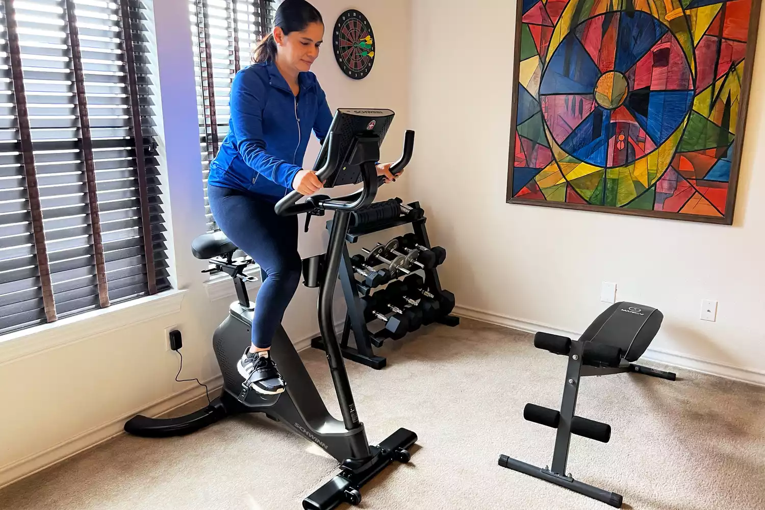 A woman using the Schwinn Upright Bike Series in an exercise room
