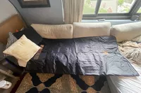 The Heat Healer Infrared Sauna Blanket on a couch