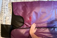 Hand resting on the HigherDose Infrared Sauna Blanket