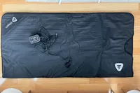 The LifePro RejuvaWrap Infrared Sauna Blanket placed on a wood floor