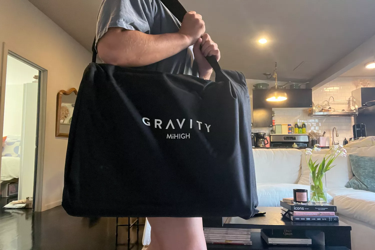 A person carries the MiHigh Infrared Sauna Blanket V2 in a bag