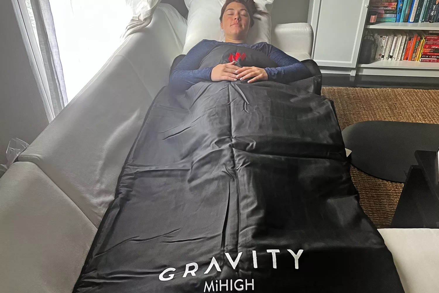 A person lies inside the MiHigh Infrared Sauna Blanket V2