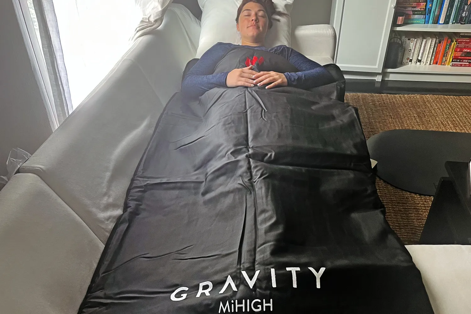 Woman laying down using MiHIGH Infrared Sauna Blanket by Gravity