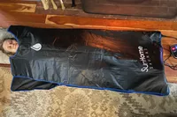 Sun Home Saunas Infrared Sauna Blanket laid out on the floor with a person using it
