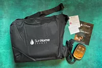 Sun Home Saunas Infrared Sauna Blanket and parts sitting on a green surface