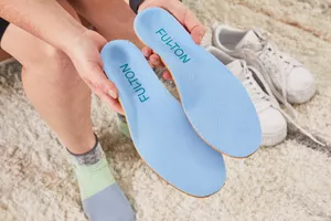 Hands holding Fulton Athletic Insoles