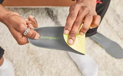 Hand folding a Superfeet Run Support Low Arch Shoe Insert