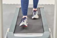 Feet walking on a treadmill