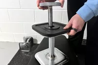 A person assembles the Ironmaster Quick-Lock 75 lb Adjustable Dumbbell System Set