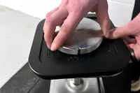 A person assembles the Ironmaster Quick-Lock 75 lb Adjustable Dumbbell System Set