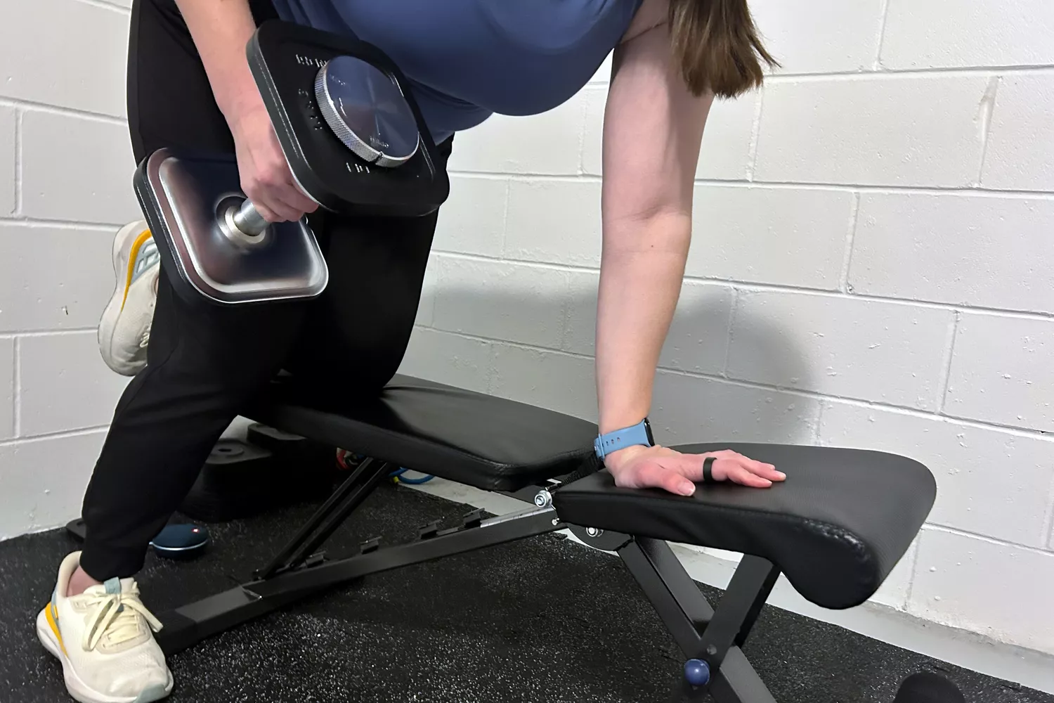 A person lifts the Ironmaster Quick-Lock 75 lb Adjustable Dumbbell System Set