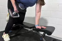 A person lifts the Ironmaster Quick-Lock 75 lb Adjustable Dumbbell System Set