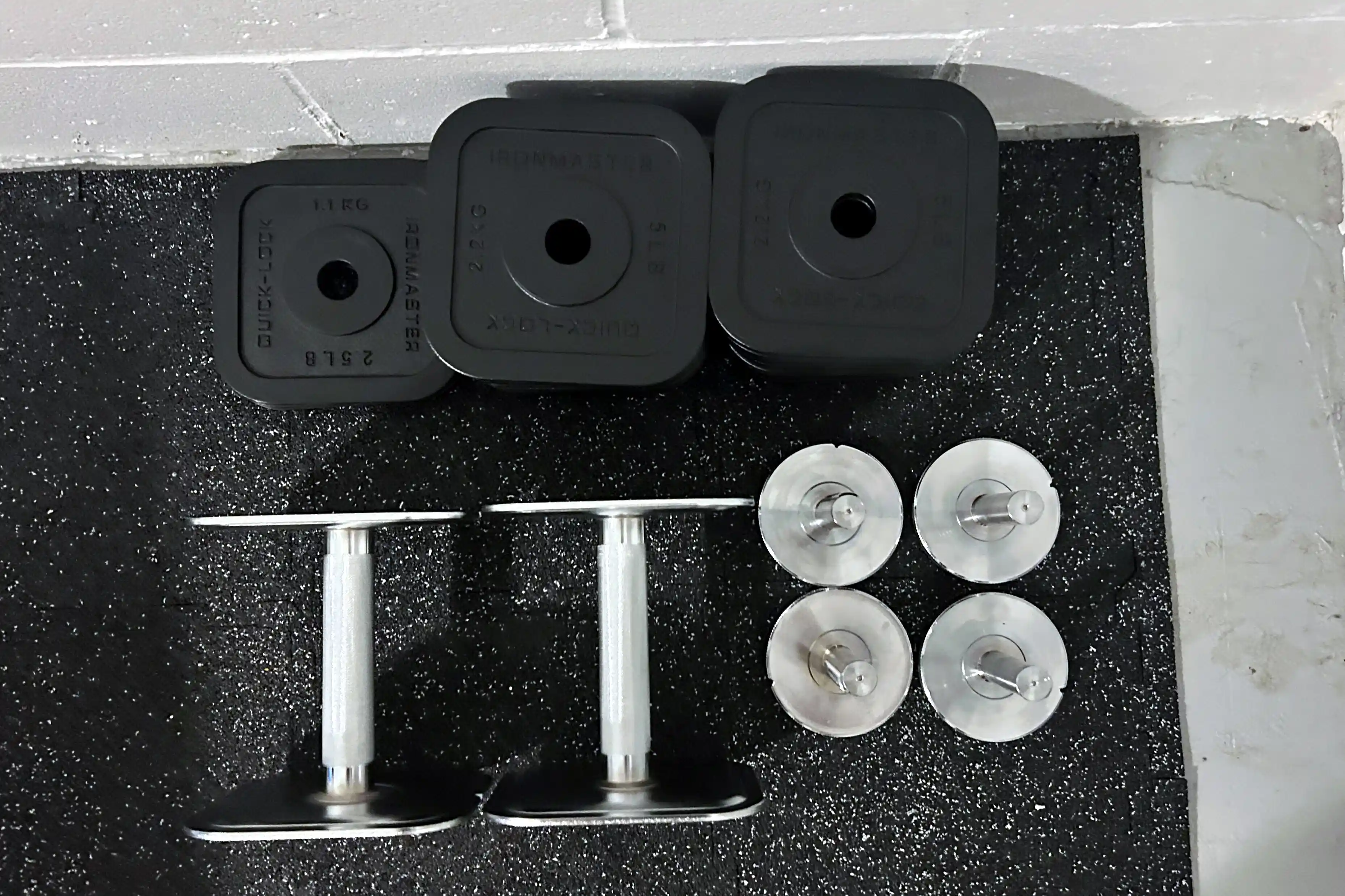 The pieces of the Ironmaster Quick-Lock 75 lb Adjustable Dumbbell System Set