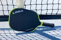 The JOOLA Anna Bright Scorpeus 3S 14mm Pickleball Paddle leans on a net