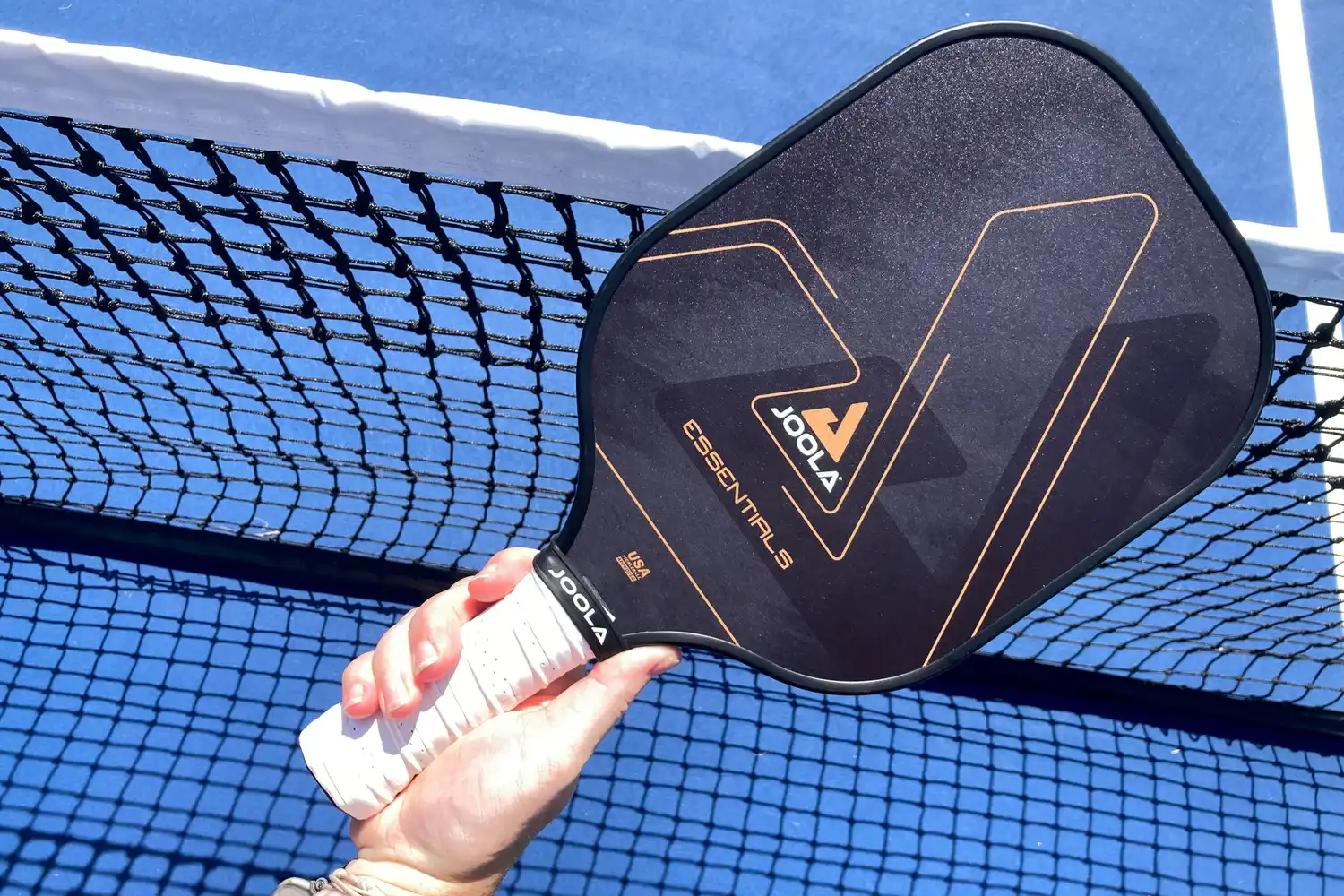 A person holds up the JOOLA Essentials Pickleball Paddle