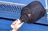 A person holds up the JOOLA Essentials Pickleball Paddle