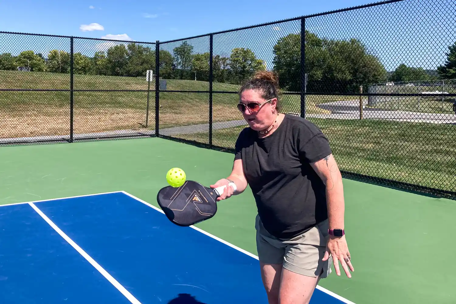 A person hits a pickleball with the JOOLA Essentials Pickleball Paddle