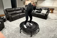 A person bounces on the JumpSport 550f 44-Inch Pro Rebounder Trampoline