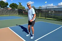 A person wears the K-Swiss Men's Pickleball Supreme Shoe on a pickleball court