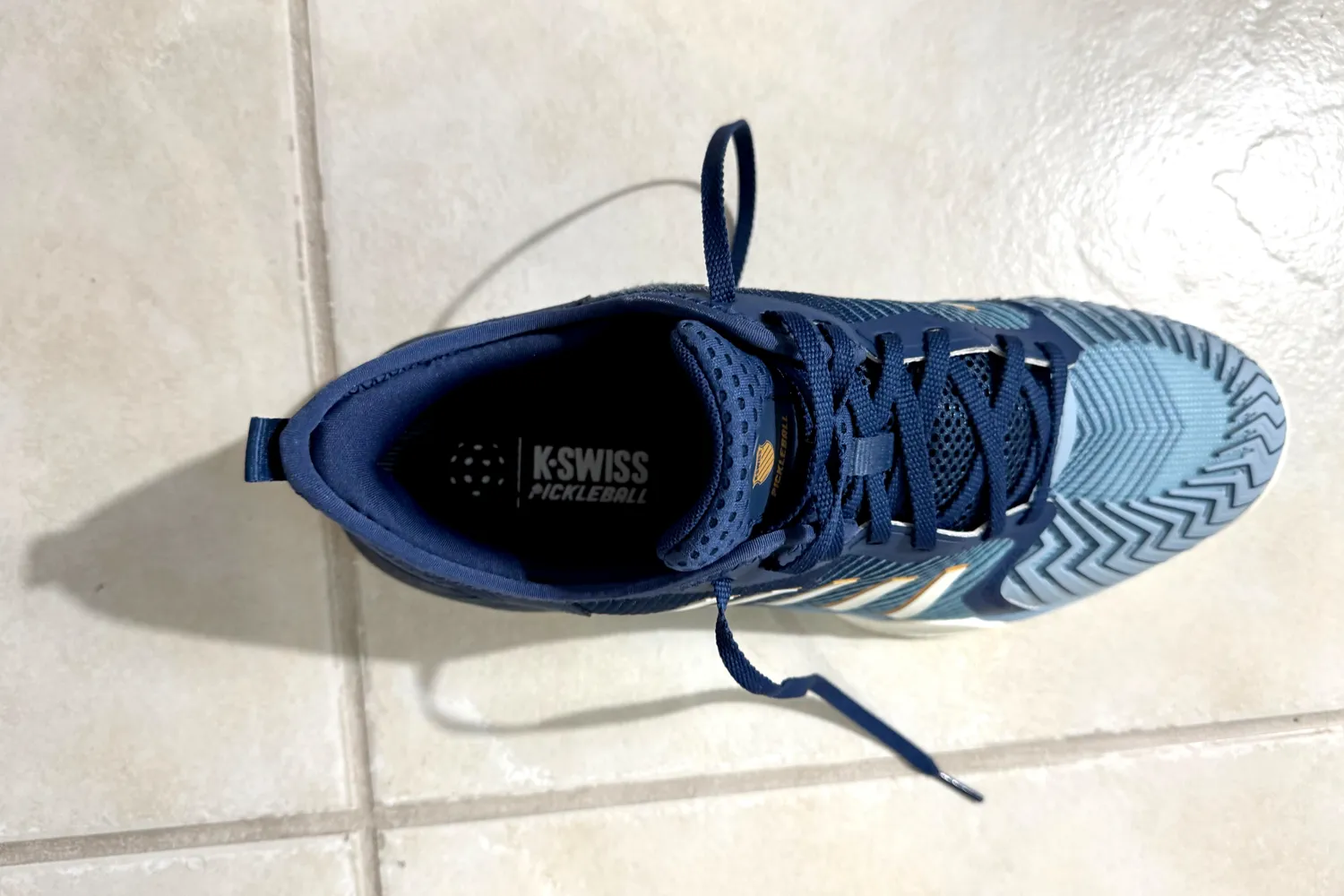 An overhead view of an untied K-Swiss Men's Pickleball Supreme Shoe