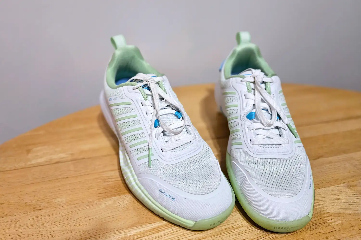 An overhead view of a pair of K-Swiss Women's Ultra Court Pickleball Shoes on a wooden table