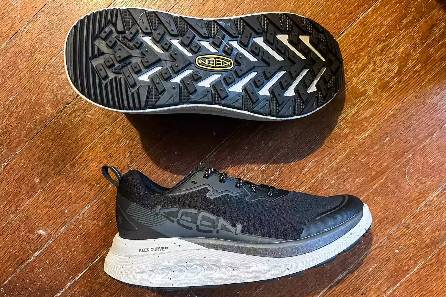 the Keen Men's WK400 II Walking Shoes posed on wood
