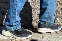 A close-up of two feet posed in the Keen Men's WK400 II Walking Shoes on stone tiles