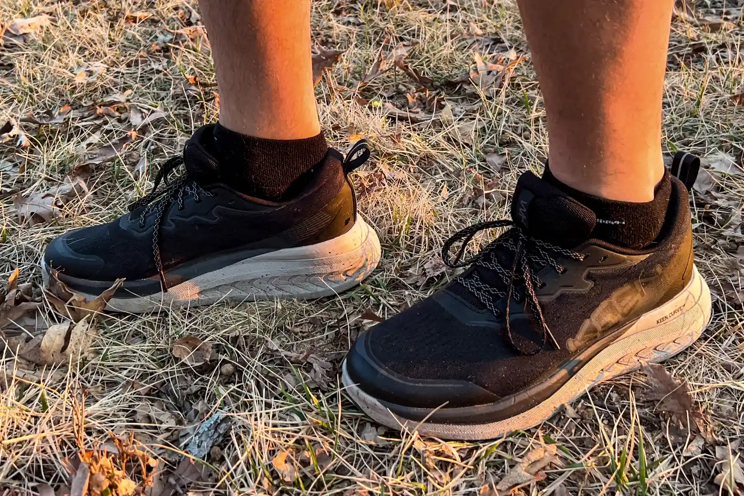 A close-up of legs wearing the Keen Men's WK400 II Walking Shoes in grass