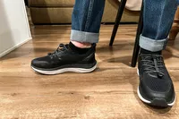 A close-up of a person's feet in the Kizik Men's London