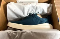 The Kizik Men's Prague 2 Sneakers in a shoebox