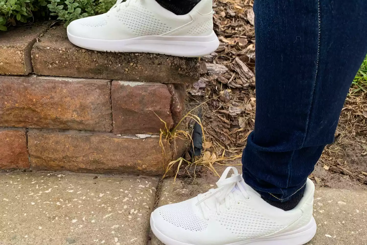 A person wears the Kizik Women's Lima Slip-on Sneakers outside