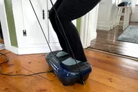 A person exercises on the LifePro HexaPlate Lite Vibration Plate
