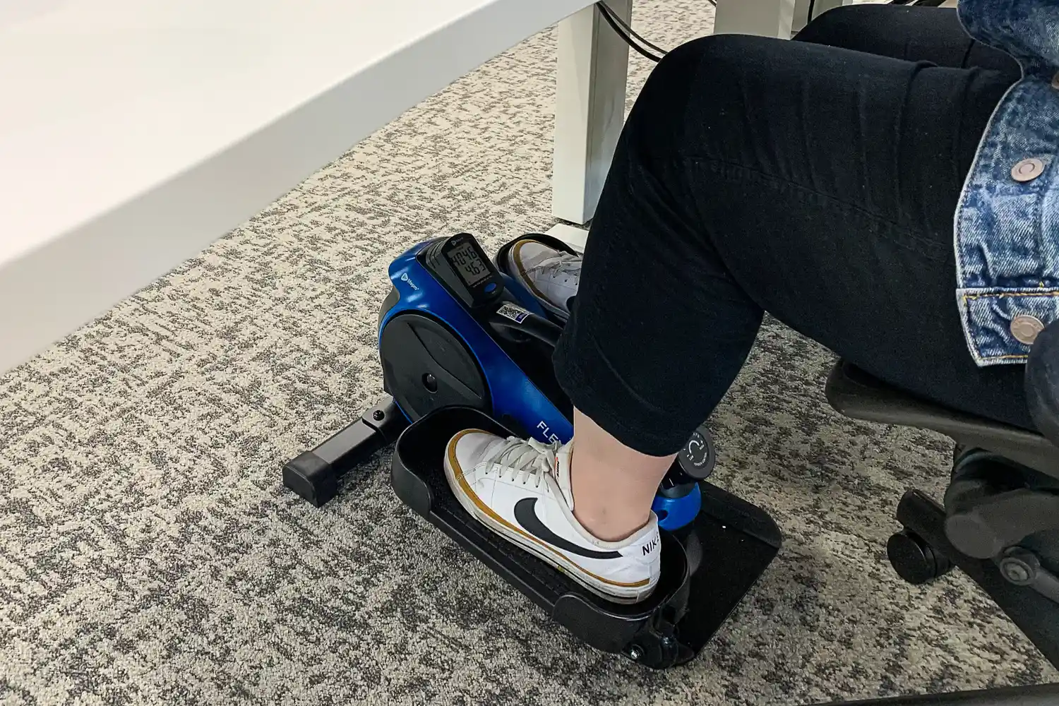 A person with their foot on the LifePro FlexStride Plus