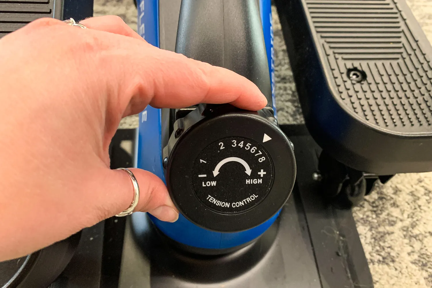 A person adjusts the dial on the LifePro FlexStride Plus