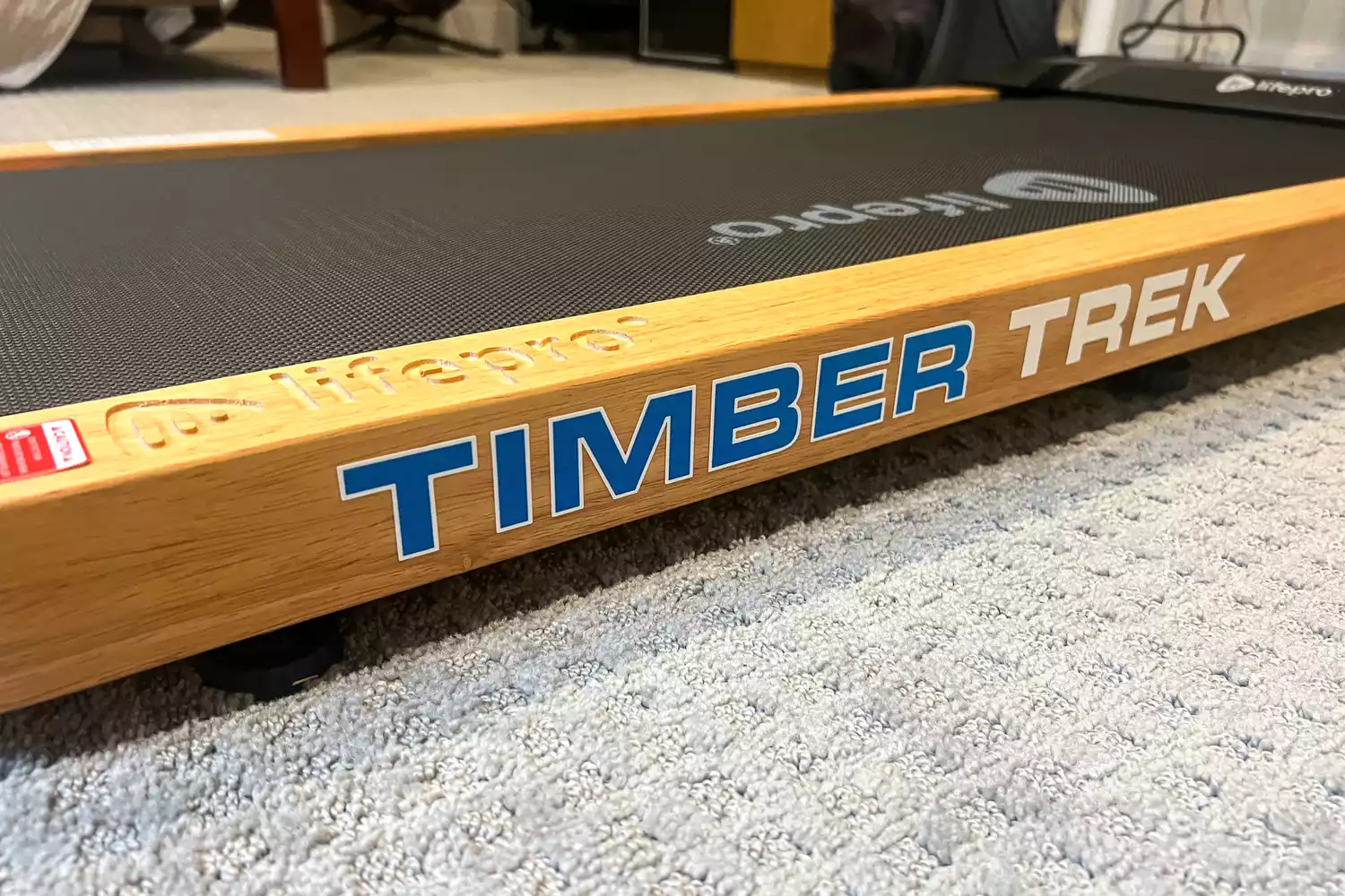 A close-up of the logo on the side of the LifePro TimberTrek Treadmill